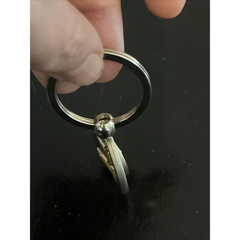 round metal Acapulco‎ souvenir keychain featuring a sailfish design